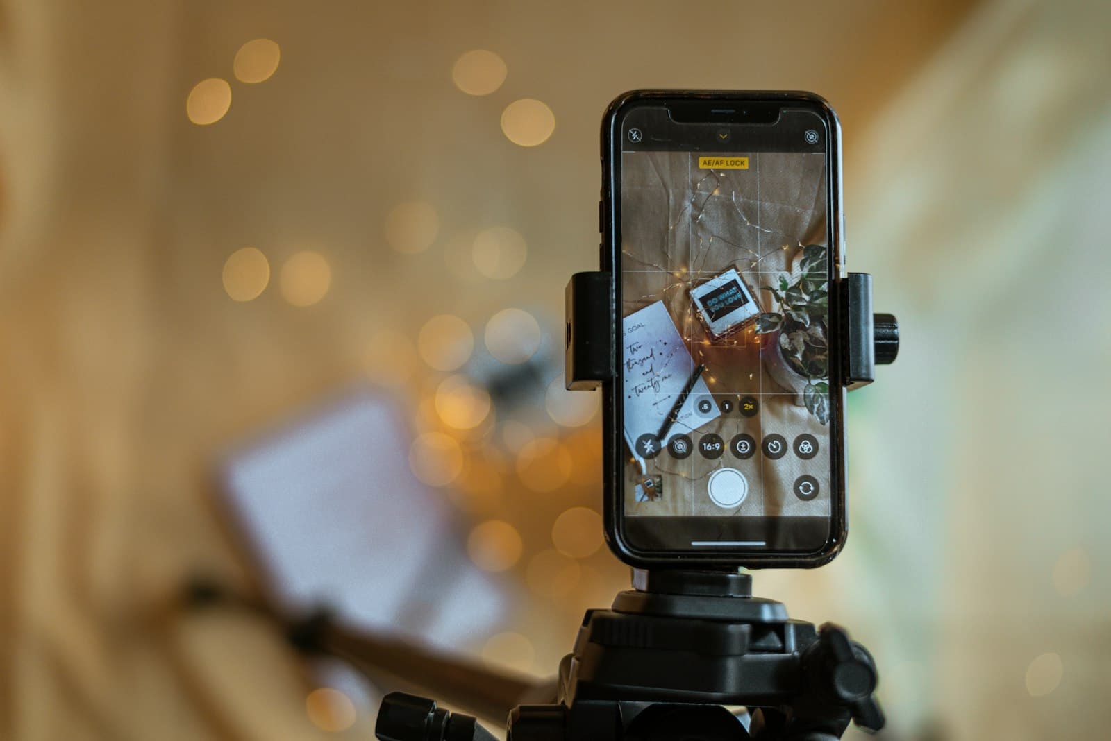 A phone on a small tripod recording at a shop counter